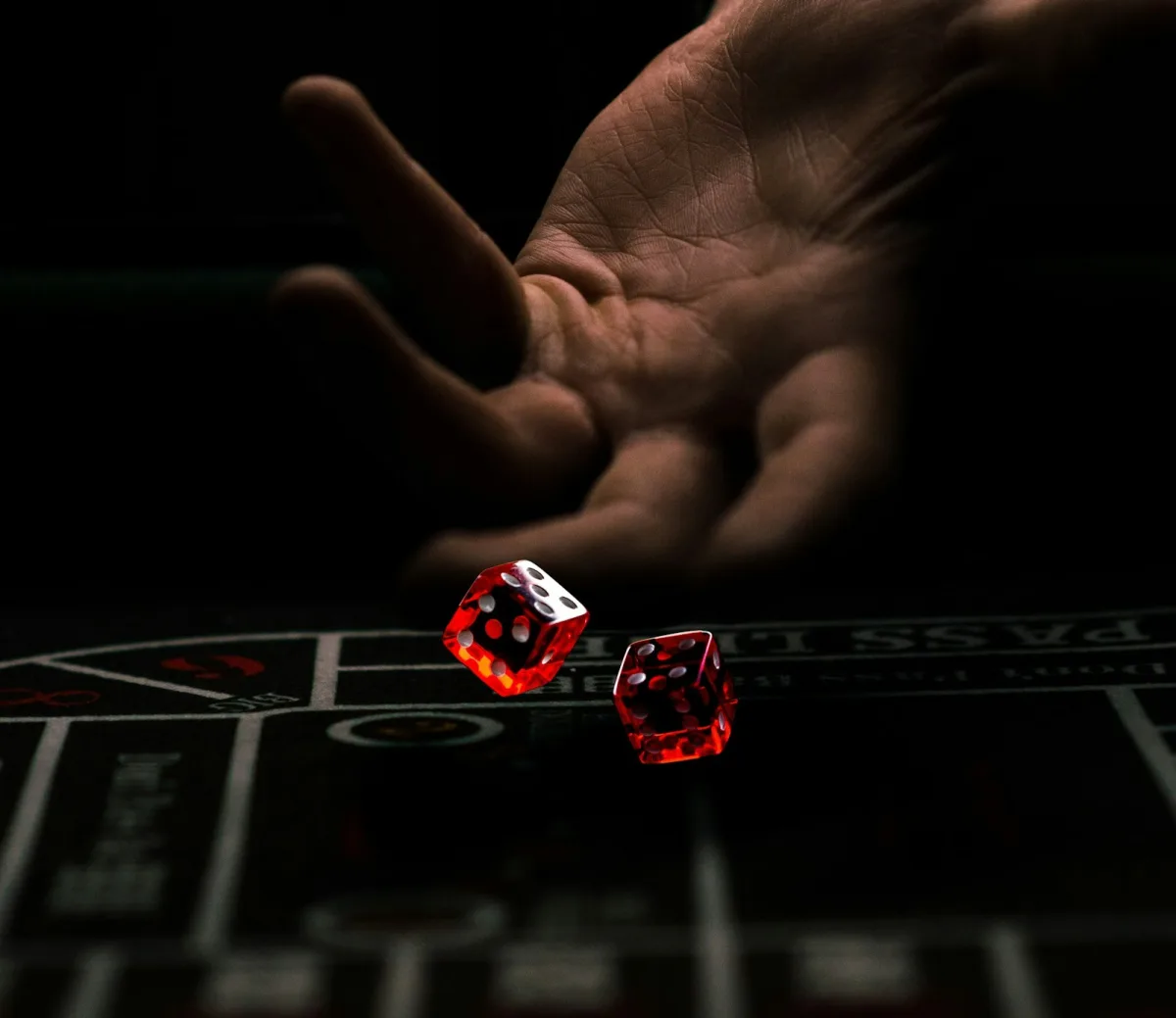 Casino dice resting on a green gaming table